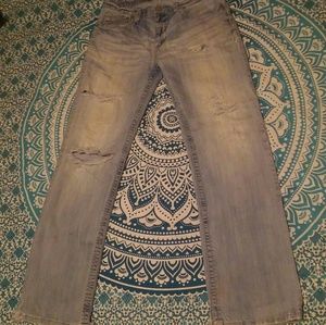 Heavily distressed denim jeans